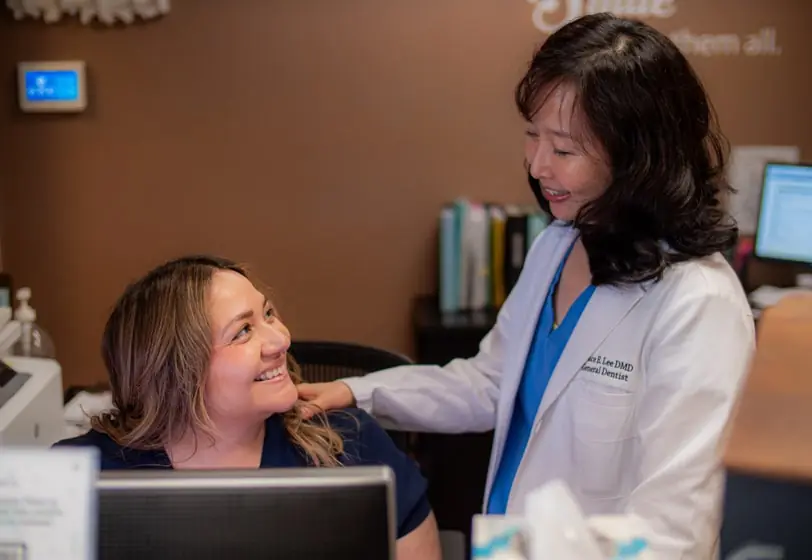 Dr. Grace Lee of Elite Dental in Chicago, IL talking with her office manager Rosie