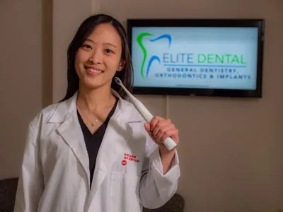 Dr. Shin holding a professional toothbrush recommended for patients
