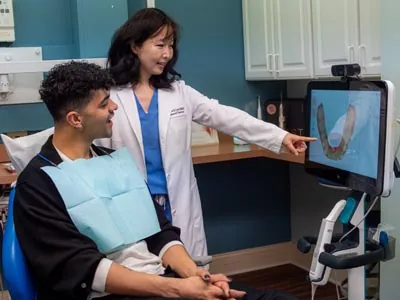 Dr. Grace Lee showing a patient their dental X-rays